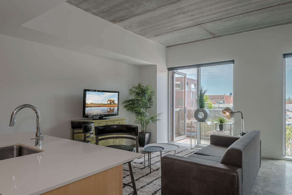 Interior apartment image with view from kitchen looking outside.