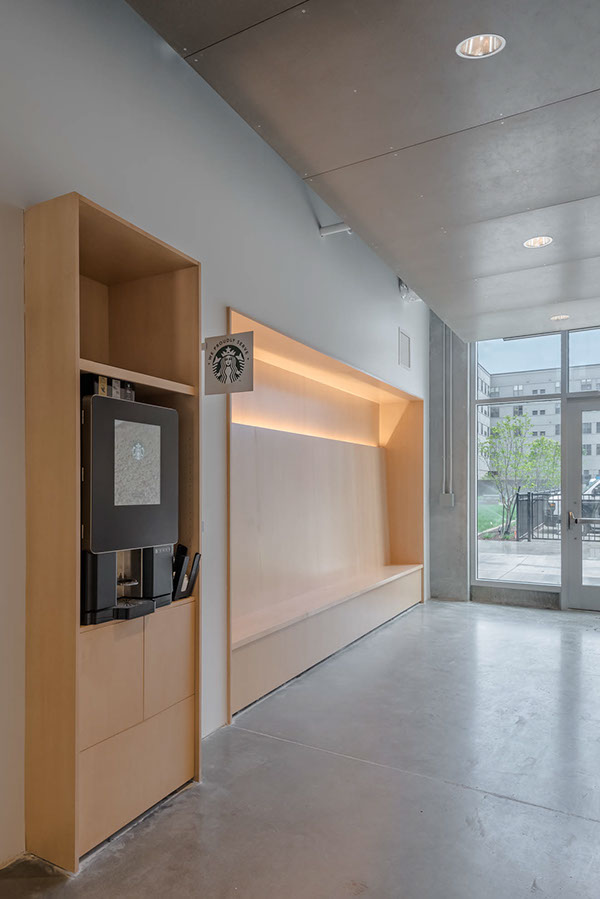 Interior apartment image with built-in wall unit and coffee maker.